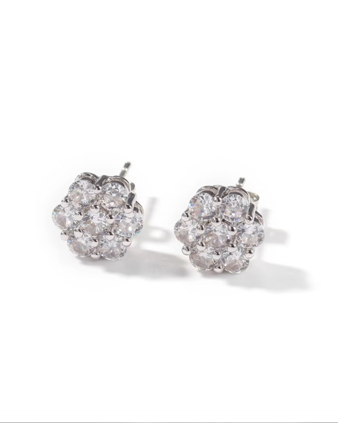 Pair of silver CZ flower cluster stud earrings on white background, floral-inspired sparkle.