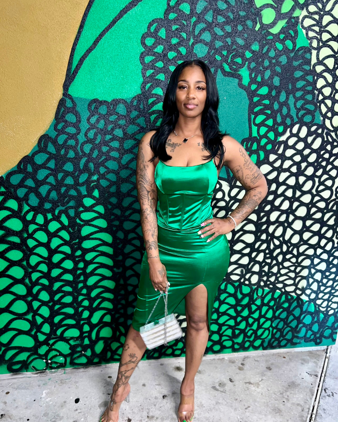 Stylish Black woman in a sleek green dress and glam heels, confidently serving a bold night-out look while rocking the I Am Enough Necklace--a luxe reminder of her power and presence.