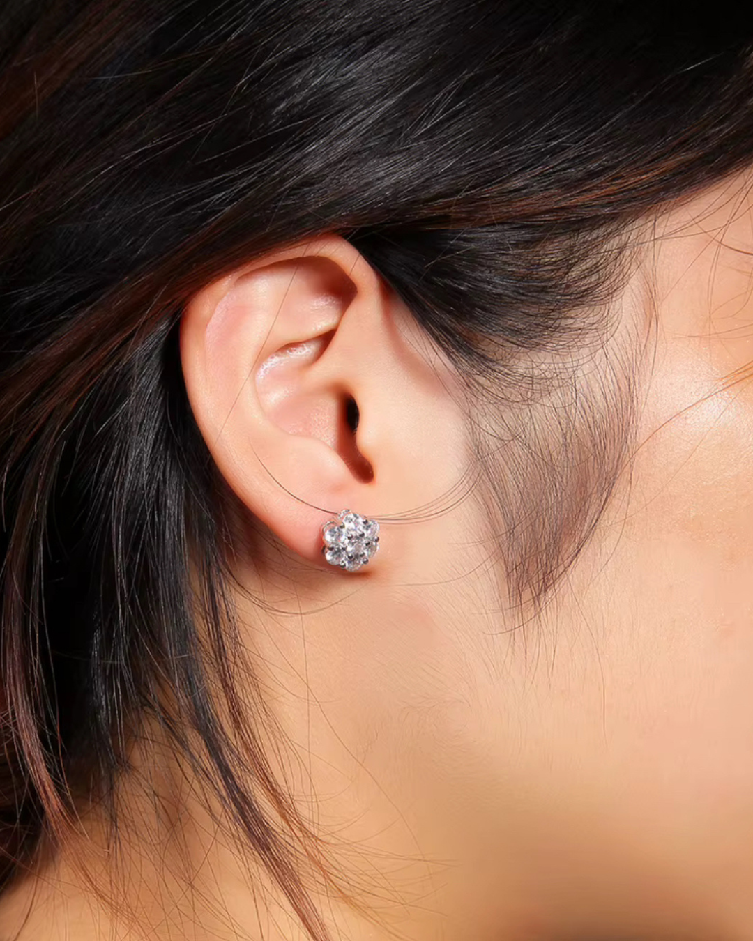 Side view of silver CZ flower cluster stud earrings on ear, lightweight floral sparkle studs.