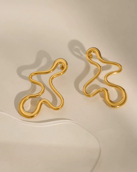 The Abstract Baddie Earrings in polished gold. Modern sculptural hoops for women who love bold, artsy, luxury statement jewelry. 
