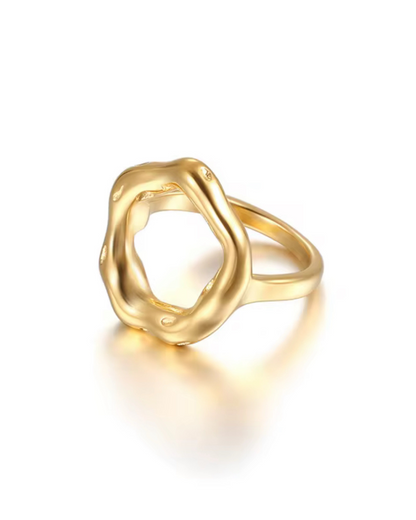 Opulence Ring – 18k gold-plated hypoallergenic oval-shaped sculpted ring with a fluid, modern design, photographed on a reflective surface.