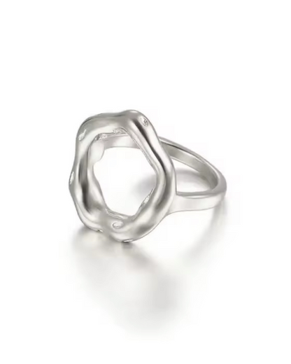 Opulence Ring – silver-plated, stainless steel, hypoallergenic oval-shaped sculpted ring with a fluid, modern design, photographed on a reflective surface.