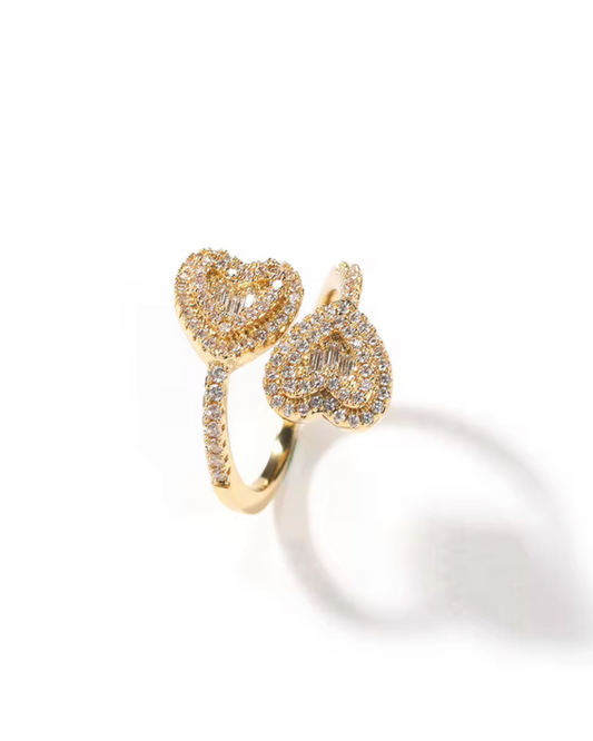 Queen of Hearts ring in gold featuring double heart shapes with CZ stones. A luxury statement ring for women who love sparkle, romance and bold style. 