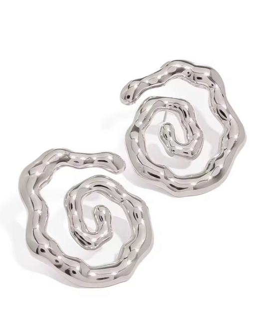 Twist of Faith earrings in polished silver, luxury sculptural circle hoops for women with modern statement style and versatile everyday-to-evening vibes. 