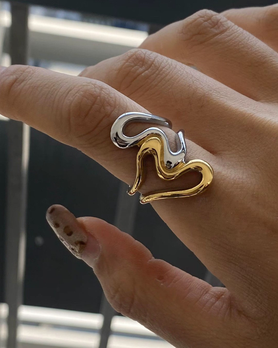 Close-up of the Untamed Ring in two-tone gold and silver, a bold sculptural statement piece worn on the hand, designed to embody fearless style and modern edge.