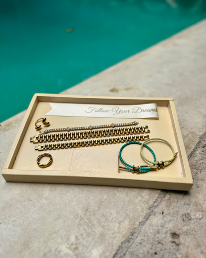 Poolside jewelry flat lay featuring the Wave Runner Ring, SneakyLink Bracelets, Stacked Like a Horse Bracelets, and the Modern Muse Ring — styled for summer vacation and resort vibes.