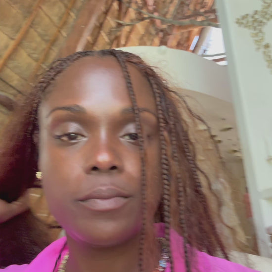 Lifestyle video of a woman wearing the In Full Bloom Necklace with multicolor CZ floral clusters, styled in a pink top and blazer, showcasing bold, feminine jewelry.