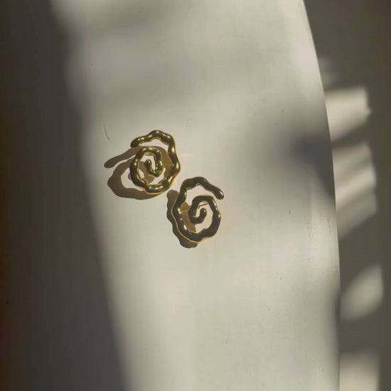 Close-up video zoom on Twist of Faith Earrings in gold, highlighting their sculptural spiral design — perfect for vacation outfits, beach getaways, and resort style looks.