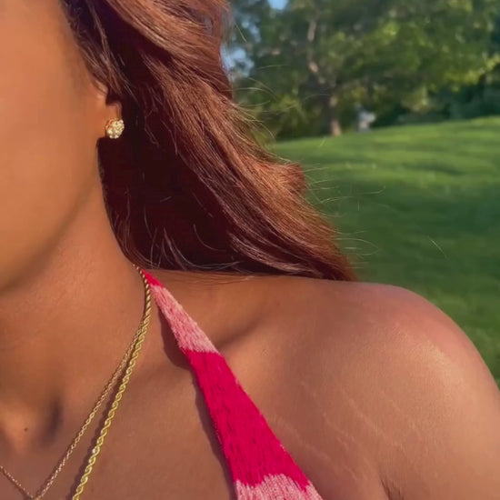 Tik Tok video of the I Am Luxury Accessories Boutique owner wearing the flower cluster gold screw back earrings.
